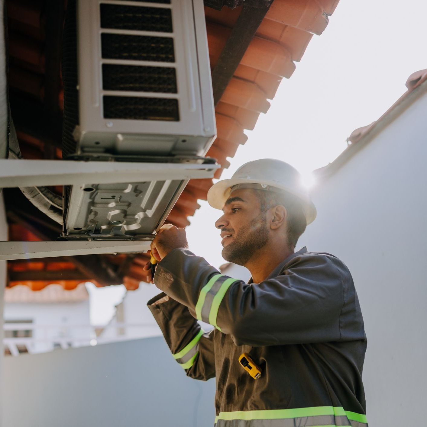 Licensed HVAC technician performing air conditioning maintenance Los Angeles